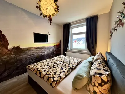 Ein Bett oder Betten in einem Zimmer der Unterkunft Ferienwohnung Midgard im Sagenharz - Family-Apartment, 2 SZ & WLAN