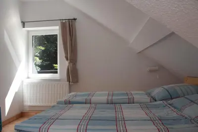 Ein Bett oder Betten in einem Zimmer der Unterkunft Ferienwohnung Forsthaus am Brocken, 55 qm, 2 Schlafzimmer F7