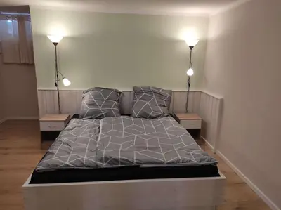 Ein Bett oder Betten in einem Zimmer der Unterkunft Gästehaus Harzklause 2