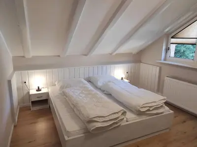 Ein Bett oder Betten in einem Zimmer der Unterkunft Gästehaus Harzklause 6