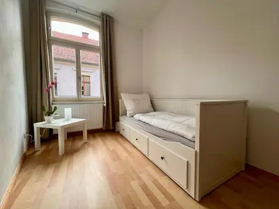 Ein Bett oder Betten in einem Zimmer der Unterkunft Ferienwohnungen Am Kaufmannshof