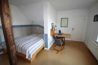 Ein Bett oder Betten in einem Zimmer der Unterkunft JS Feriendomizile: FeWo Nest