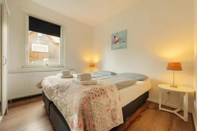 Ein Bett oder Betten in einem Zimmer der Unterkunft Haus Sonneck - Apartmenthaus - Sonnenterrasse mit Grill - 1-8 Personen - ruhige Lage mit Blick über Braunlage