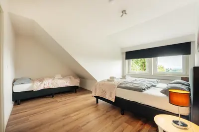 Ein Bett oder Betten in einem Zimmer der Unterkunft Haus Sonneck - Apartmenthaus - Sonnenterrasse mit Grill - 1-8 Personen - ruhige Lage mit Blick über Braunlage