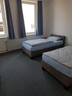 Ein Bett oder Betten in einem Zimmer der Unterkunft Gästehaus Harzstraße