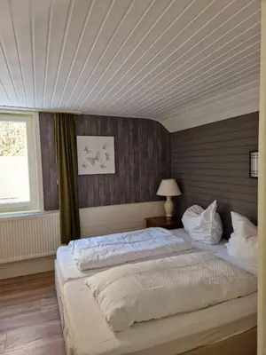 Ein Bett oder Betten in einem Zimmer der Unterkunft Harz Hotel Waldhaus