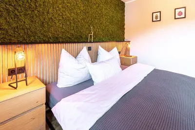 Ein Bett oder Betten in einem Zimmer der Unterkunft Waldbewohner Apartments / Hirsch
