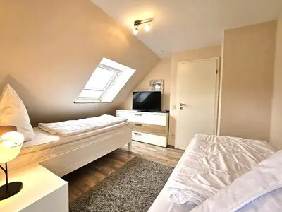 Ein Bett oder Betten in einem Zimmer der Unterkunft Design Apartment Grünwald große Wohnung auf 2 Etagen