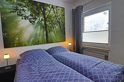 Ein Bett oder Betten in einem Zimmer der Unterkunft Lichtblick Hahnenklee - Happy Harz
