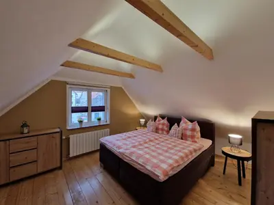 Ein Bett oder Betten in einem Zimmer der Unterkunft Ferienhaus Am Brunnen