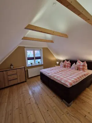 Ein Bett oder Betten in einem Zimmer der Unterkunft Ferienhaus Am Brunnen