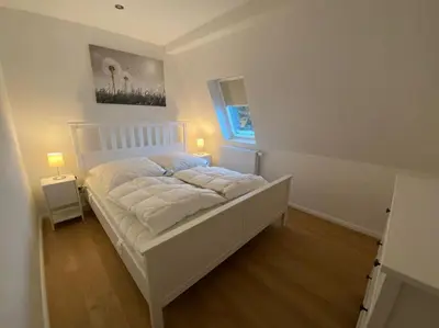 Ein Bett oder Betten in einem Zimmer der Unterkunft FeWo Luxusblick