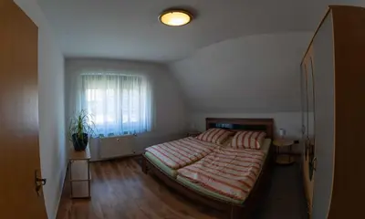 Ein Bett oder Betten in einem Zimmer der Unterkunft Ferienwohnung Zeiß