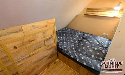 Ein Bett oder Betten in einem Zimmer der Unterkunft Arode Alte Schmiedemühle