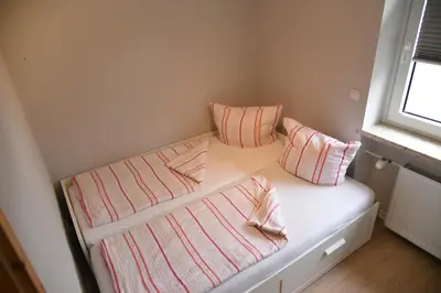 Ein Bett oder Betten in einem Zimmer der Unterkunft Roter Beer