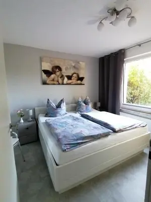 Ein Bett oder Betten in einem Zimmer der Unterkunft Ferienwohnung 'Auszeit Parkresidenz'