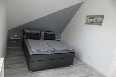 Ein Bett oder Betten in einem Zimmer der Unterkunft Ferienwohnung Wolfswiese