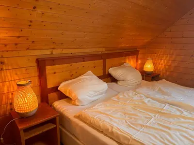 Ein Bett oder Betten in einem Zimmer der Unterkunft Auerhahn Ferienhäuser Auerhahn 510