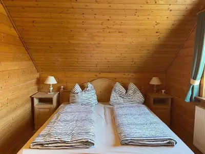 Ein Bett oder Betten in einem Zimmer der Unterkunft Ferienhaus Blauvogel 19