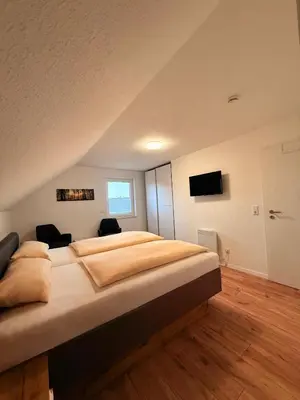 Ein Bett oder Betten in einem Zimmer der Unterkunft Auerhahn Ferienhäuser Haus Tajo