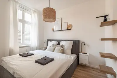 Ein Bett oder Betten in einem Zimmer der Unterkunft REGIOHOTEL Am Nicolaiplatz Wernigerode - #Ferienwohnungen #FrischRenoviert #Kaffeevollautomat #Bestlage