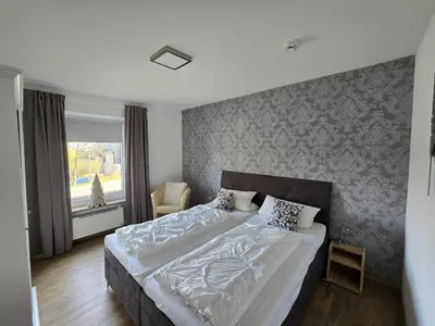 Ein Bett oder Betten in einem Zimmer der Unterkunft Ferienwohnung Am Hasselkopf 1