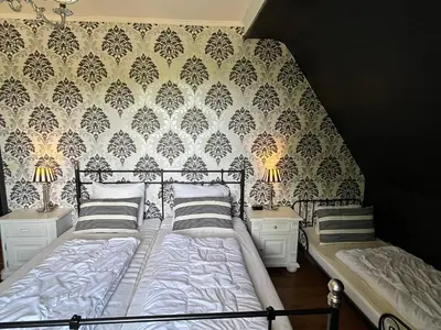 Ein Bett oder Betten in einem Zimmer der Unterkunft Ferienwohnung Hexenkessel in der Villa Brockenhexe