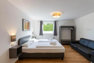 Ein Bett oder Betten in einem Zimmer der Unterkunft Ferienhaus BergZeit mit Garten, Grill, Terrasse, maximal 20 Personen