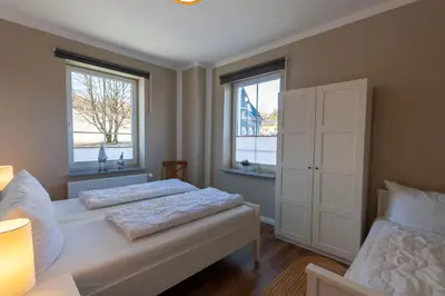 Ein Bett oder Betten in einem Zimmer der Unterkunft Ferienwohnung Morgenrot in der Villa Harzer Flair