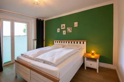 Ein Bett oder Betten in einem Zimmer der Unterkunft Ferienwohnung Am Bach 1 mit Terrasse