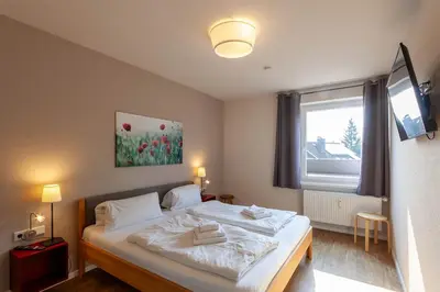 Ein Bett oder Betten in einem Zimmer der Unterkunft Ferienwohnung Lichtblick mit Balkon und Garage