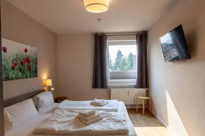 Ein Bett oder Betten in einem Zimmer der Unterkunft Ferienwohnung Lichtblick mit Balkon und Garage