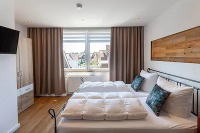 Ein Bett oder Betten in einem Zimmer der Unterkunft Ferienwohnung Waldfrieden 3 mit Dachterrasse und Grill