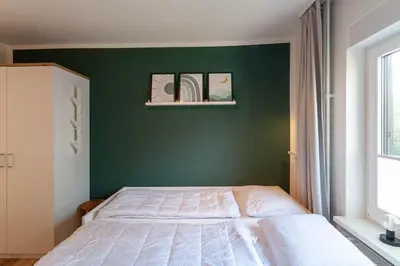 Ein Bett oder Betten in einem Zimmer der Unterkunft Ferienwohnung Somnia mit Balkon