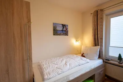 Ein Bett oder Betten in einem Zimmer der Unterkunft Ferienwohnung Marit mit Balkon
