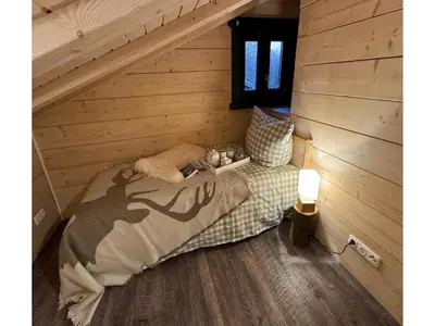 Ein Bett oder Betten in einem Zimmer der Unterkunft Blockhütte im Harz mit Sauna und Kamin