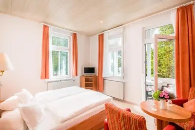 Ein Bett oder Betten in einem Zimmer der Unterkunft Hotel Flora