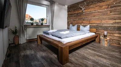 Ein Bett oder Betten in einem Zimmer der Unterkunft Gemütliches Chalet-Apartment Harzglück am Fuß des Berges