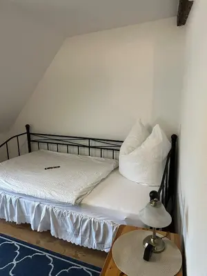 Ein Bett oder Betten in einem Zimmer der Unterkunft Ferienwohnung Fachwerkstube
