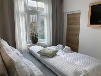 Ein Bett oder Betten in einem Zimmer der Unterkunft Villa Schlossblick III - Zeit zum Träumen in exklusiver Suite 