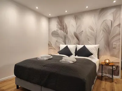 Ein Bett oder Betten in einem Zimmer der Unterkunft ApartZ - Bad Harzburg - HarzPause - Infrarotsauna - Parkplatz - Balkon - Regendusche