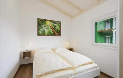 Ein Bett oder Betten in einem Zimmer der Unterkunft Ferienhausdorf Thale