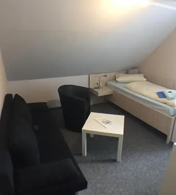 Ein Bett oder Betten in einem Zimmer der Unterkunft Blechleppel - Die Pension im Harz