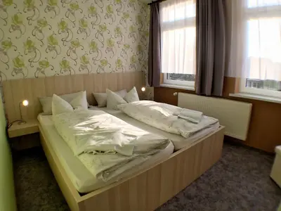 Ein Bett oder Betten in einem Zimmer der Unterkunft Blechleppel - Die Pension im Harz