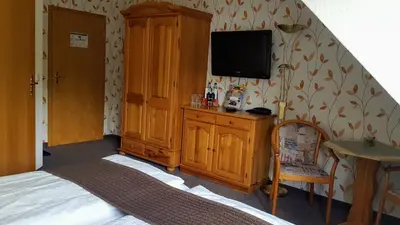Ein Bett oder Betten in einem Zimmer der Unterkunft Kurhotel Bad Suderode