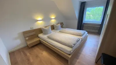 Ein Bett oder Betten in einem Zimmer der Unterkunft Ferienhaus Goethestrasse