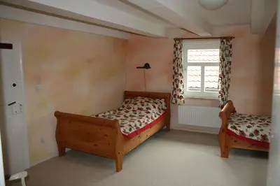 Ein Bett oder Betten in einem Zimmer der Unterkunft Apartments Café Brennnessel
