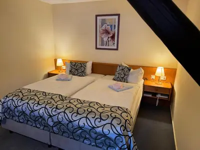Ein Bett oder Betten in einem Zimmer der Unterkunft Hotel Zum Kanzler