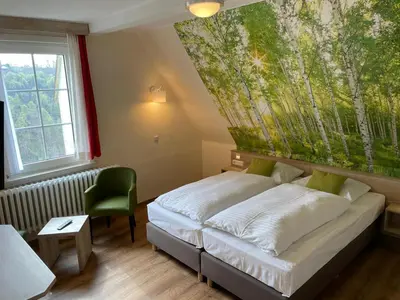 Ein Bett oder Betten in einem Zimmer der Unterkunft Berghotel Glockenberg