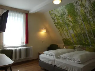 Ein Bett oder Betten in einem Zimmer der Unterkunft Berghotel Glockenberg
